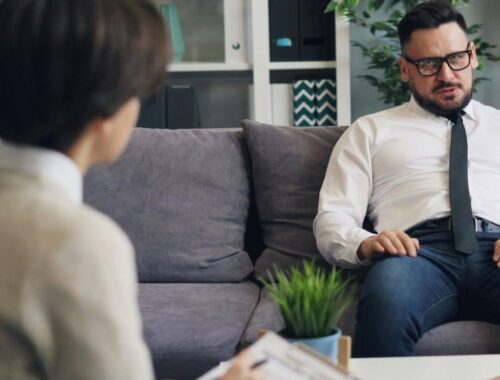 Workplace conversation showing an employee speaking with a supportive colleague, relevant to Standard Mental Health First Aid training in Australia.