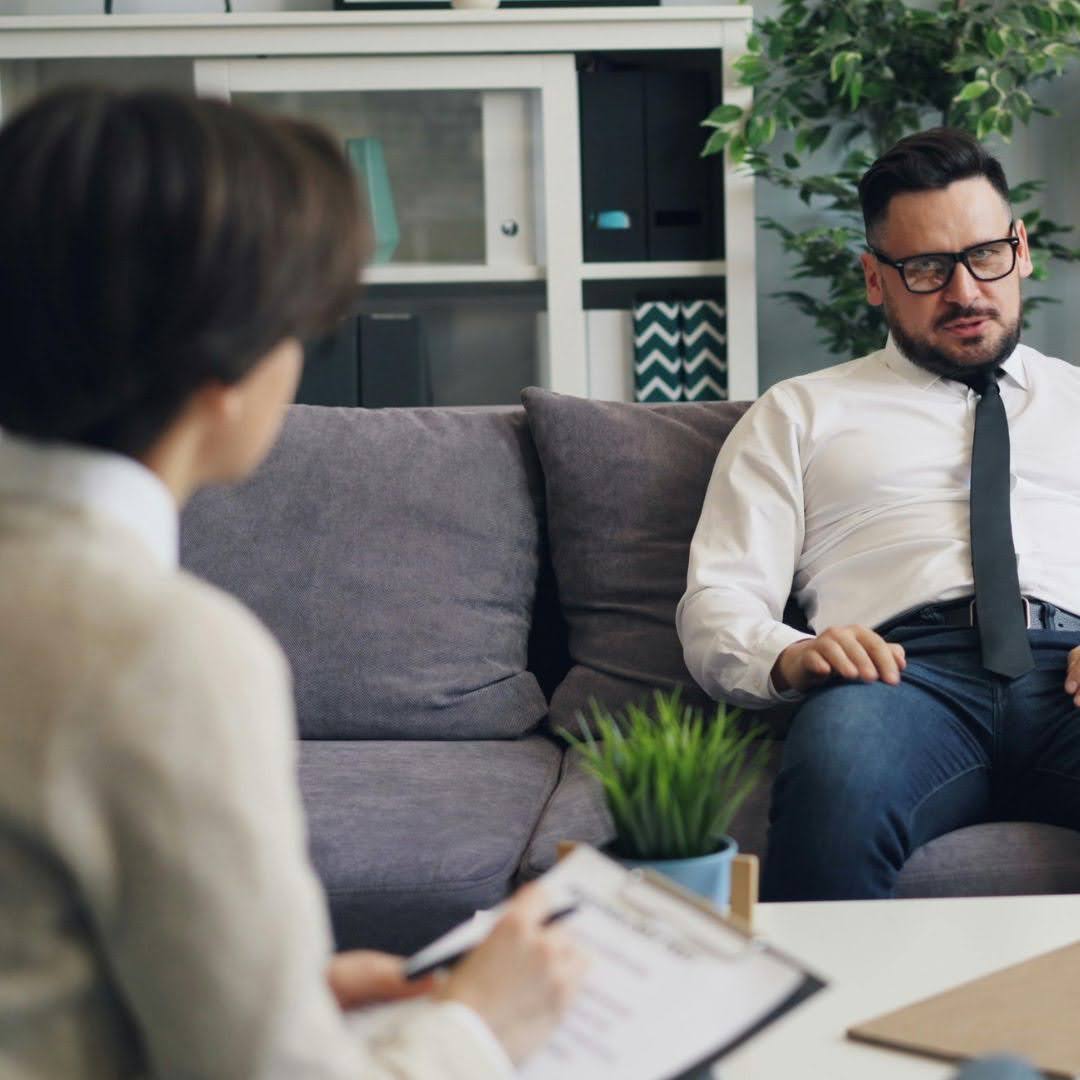 Workplace conversation showing an employee speaking with a supportive colleague, relevant to Standard Mental Health First Aid training in Australia.