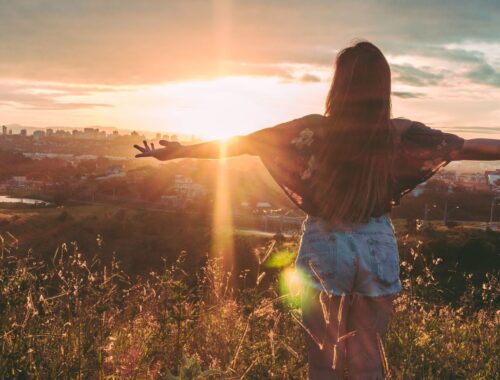 Person standing outdoors at sunset, representing workplace wellbeing sessions and short courses in Australia.