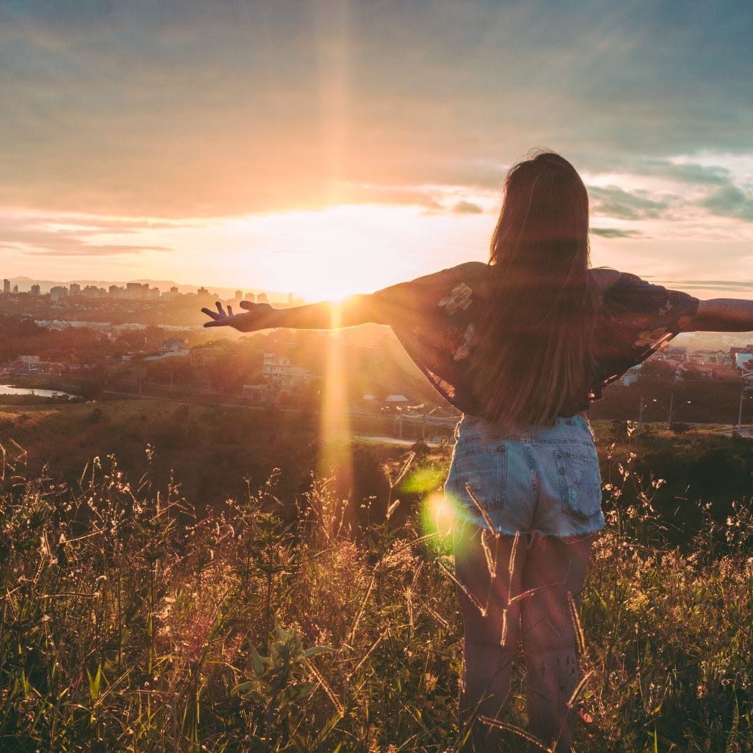 Person standing outdoors at sunset, representing workplace wellbeing sessions and short courses in Australia.