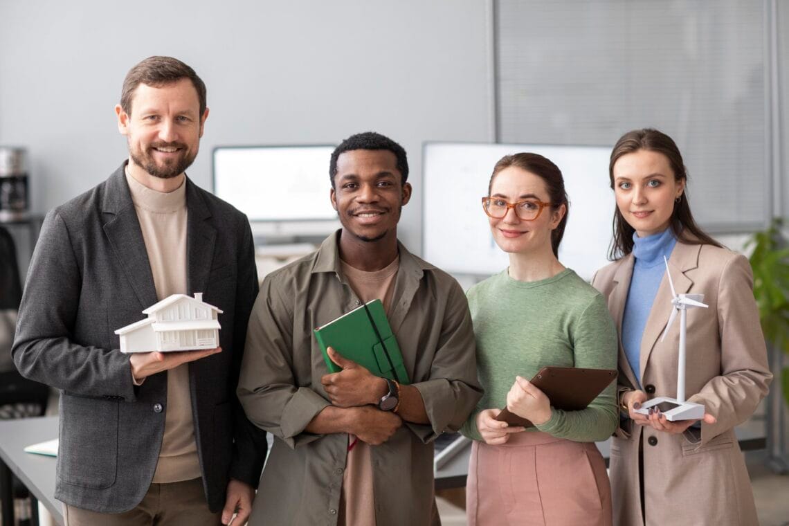 Team members standing together with learning materials, representing CBT and DBT life skills training for managing emotions, stress and wellbeing in Australia.