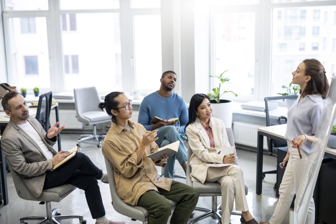Diverse employees and teams taking part in a workplace learning session, representing wellbeing and mental health training in Australia.
