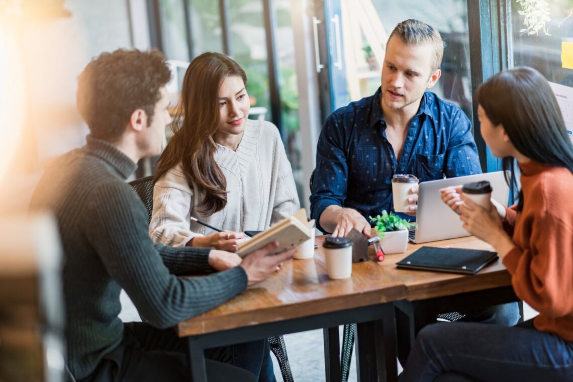 Workplace team in a focused group discussion, representing psychological safety training for employees and teams in Australia.